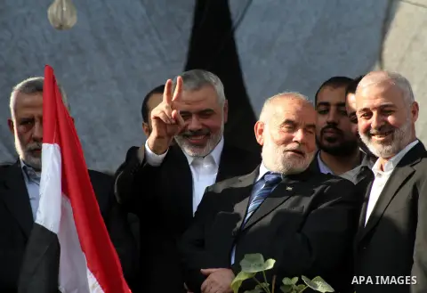 Palestinian prime minister in Gaza Ismail Haniyeh and Islamic Jihad leader Mohammed Al-Hindi, senior Fatah official Nabil Shaath and deputy speaker of Palestinian Parliament Ahmed Bahar celebrate what Palestinians say is...