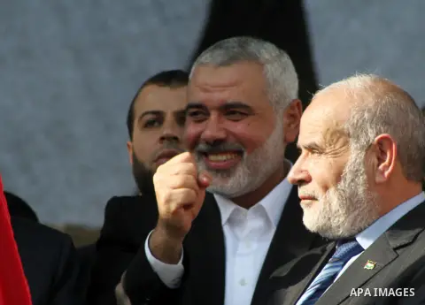 Palestinian prime minister in Gaza Ismail Haniyeh and Islamic Jihad leader Mohammed Al-Hindi, senior Fatah official Nabil Shaath and deputy speaker of Palestinian Parliament Ahmed Bahar celebrate what Palestinians say is...