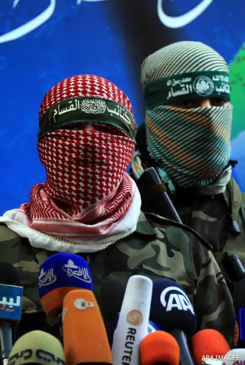 Abu Obaida , the spokesman for the Ezzedine Al-Qassam Brigades, the armed wing of Hamas, speaks during a news conference in Gaza City on November 22, 2012 at the house of their late leader Ahmed Jaabari, who was killed w...