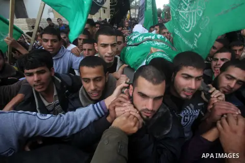 Palestinians carry the body of Anwar Qudih, 20, during his funeral in Khan Younis, southern Gaza Strip, Nov. 23, 2012. Israeli troops at the Gaza border shot dead Qudeh and wounded 15 more on Friday, health officials sai...