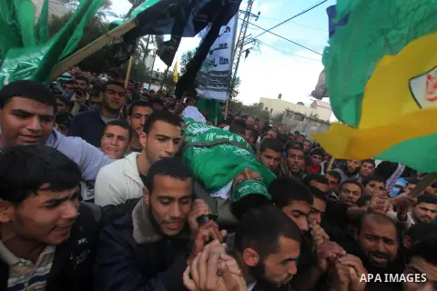 Palestinians carry the body of Anwar Qudih, 20, during his funeral in Khan Younis, southern Gaza Strip, Nov. 23, 2012. Israeli troops at the Gaza border shot dead Qudeh and wounded 15 more on Friday, health officials sai...