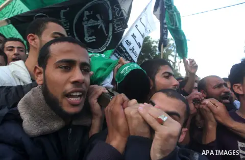 Palestinians carry the body of Anwar Qudih, 20, during his funeral in Khan Younis, southern Gaza Strip, Nov. 23, 2012. Israeli troops at the Gaza border shot dead Qudeh and wounded 15 more on Friday, health officials sai...