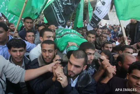 Palestinians carry the body of Anwar Qudih, 20, during his funeral in Khan Younis, southern Gaza Strip, Nov. 23, 2012. Israeli troops at the Gaza border shot dead Qudeh and wounded 15 more on Friday, health officials sai...