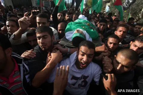 Palestinians carry the body of Anwar Qudih, 20, during his funeral in Khan Younis, southern Gaza Strip, Nov. 23, 2012. Israeli troops at the Gaza border shot dead Qudeh and wounded 15 more on Friday, health officials sai...