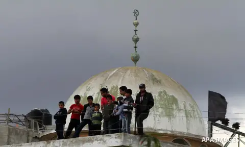 Palestinians look at the body of Anwar Qudih, 20, during his funeral in Khan Younis, southern Gaza Strip, Nov. 23, 2012. Israeli troops at the Gaza border shot dead Qudeh and wounded 15 more on Friday, health officials s...