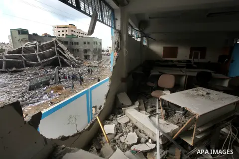 Palestinians school girls walk on the rubble of a building destroyed during earlier Israeli bombardment, as they make their way to their nearby school in Gaza City, on November 24, 2012, three days after a truce was decl...