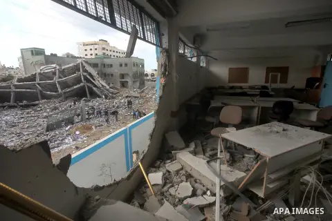 Palestinians school girls walk on the rubble of a building destroyed during earlier Israeli bombardment, as they make their way to their nearby school in Gaza City, on November 24, 2012, three days after a truce was decl...