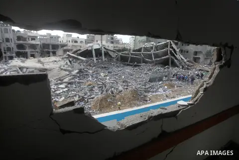 A Palestinian school boy looks through a hole at their damaged United Nations run school in Gaza City, on November 24, 2012, three days after a truce was declared between Israel and Hamas. Gaza's children, virtually abse...