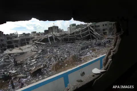 Palestinians school girls walk on the rubble of a building destroyed during earlier Israeli bombardment, as they make their way to their nearby school in Gaza City, on November 24, 2012, three days after a truce was decl...