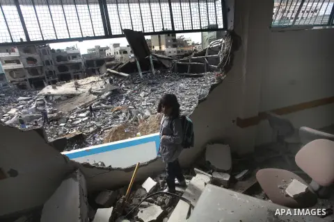 Palestinians school girls walk on the rubble of a building destroyed during earlier Israeli bombardment, as they make their way to their nearby school in Gaza City, on November 24, 2012, three days after a truce was decl...