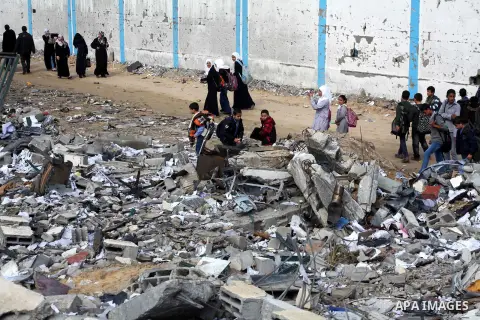 Palestinians school girls walk on the rubble of a building destroyed during earlier Israeli bombardment, as they make their way to their nearby school in Gaza City, on November 24, 2012, three days after a truce was decl...