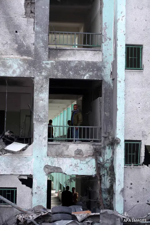 Palestinians stand at the rubble of a house, which was destroyed by an Israeli airstrike, in Gaza City on Nov. 24, 2012. Israel and Palestinian militant groups in the Gaza Strip reached a ceasefire agreement on Wednesday...