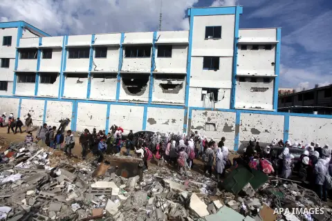 Palestinians school girls walk on the rubble of a building destroyed during earlier Israeli bombardment, as they make their way to their nearby school in Gaza City, on November 24, 2012, three days after a truce was decl...