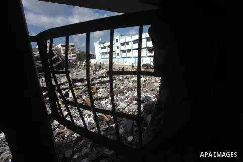 A Palestinian school boy looks through a hole at their damaged United Nations run school in Gaza City, on November 24, 2012, three days after a truce was declared between Israel and Hamas. Gaza's children, virtually abse...