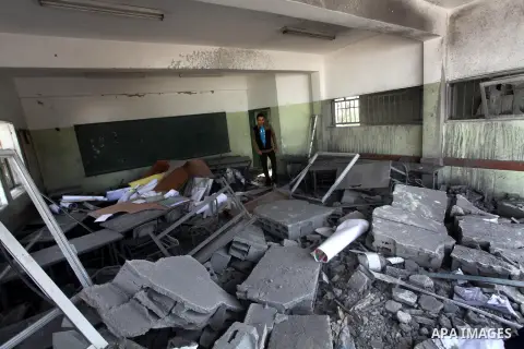 Palestinians school girls walk on the rubble of a building destroyed during earlier Israeli bombardment, as they make their way to their nearby school in Gaza City, on November 24, 2012, three days after a truce was decl...