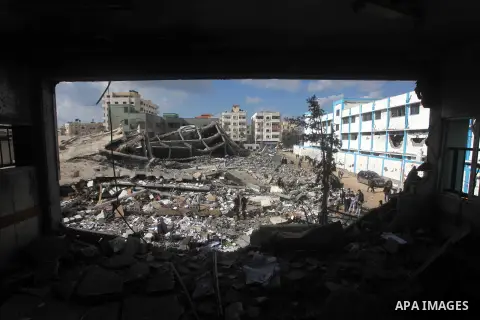 A Palestinian school boy looks through a hole at their damaged United Nations run school in Gaza City, on November 24, 2012, three days after a truce was declared between Israel and Hamas. Gaza's children, virtually abse...