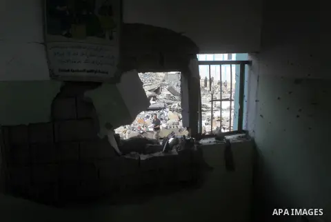 A Palestinian school boy looks through a hole at their damaged United Nations run school in Gaza City, on November 24, 2012, three days after a truce was declared between Israel and Hamas. Gaza's children, virtually abse...