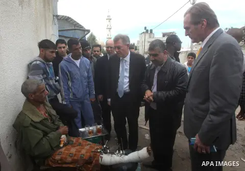 Robert H. Serry, the United Nations special coordinator for the Middle East Peace Process, talks with a wounded Palestinian man during his visit to Gaza Strip in Gaza City on Nov. 25, 2012. Photo by Ashraf Amra