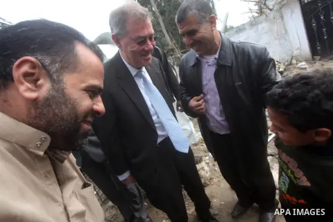 Robert H. Serry, the United Nations special coordinator for the Middle East Peace Process, talks with a wounded Palestinian man during his visit to Gaza Strip in Gaza City on Nov. 25, 2012. Photo by Ashraf Amra