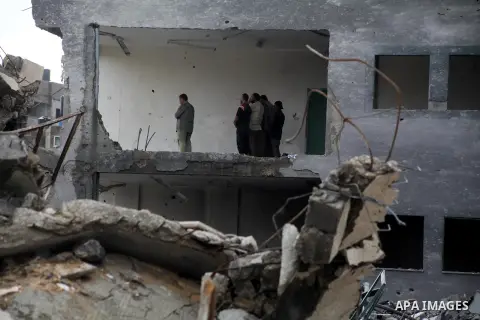Employees of the Palestinian Interior ministry pray in the rubble of the Interior Ministry building in Gaza City on November 25, 2012, days after a truce between Hamas and Israel, ended eight days of cross border attacks...