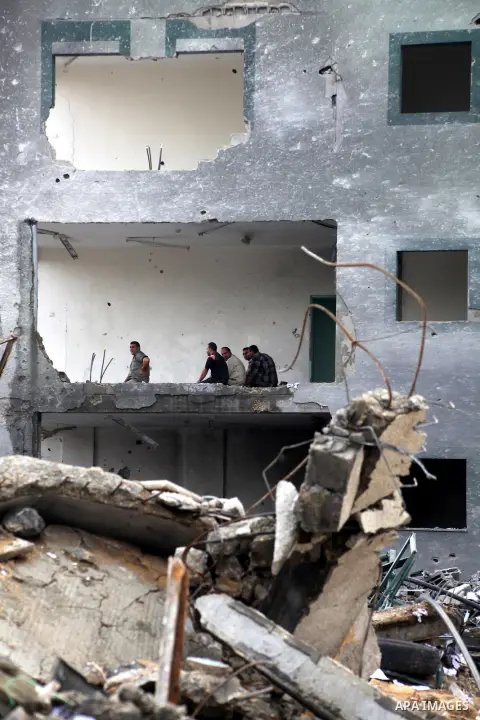 Employees of the Palestinian Interior ministry pray in the rubble of the Interior Ministry building in Gaza City on November 25, 2012, days after a truce between Hamas and Israel, ended eight days of cross border attacks...