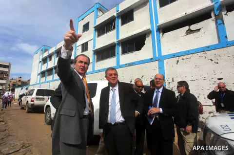 Robert H. Serry, the United Nations special coordinator for the Middle East Peace Process, talks with a wounded Palestinian man during his visit to Gaza Strip in Gaza City on Nov. 25, 2012. Photo by Ashraf Amra