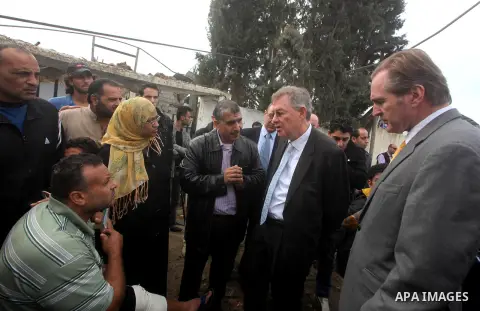 Robert H. Serry, the United Nations special coordinator for the Middle East Peace Process, talks with a wounded Palestinian man during his visit to Gaza Strip in Gaza City on Nov. 25, 2012. Photo by Ashraf Amra