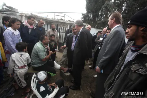 Robert H. Serry, the United Nations special coordinator for the Middle East Peace Process, talks with a wounded Palestinian man during his visit to Gaza Strip in Gaza City on Nov. 25, 2012. Photo by Ashraf Amra