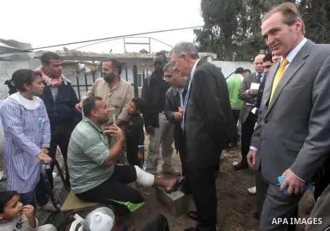 Robert H. Serry, the United Nations special coordinator for the Middle East Peace Process, talks with a wounded Palestinian man during his visit to Gaza Strip in Gaza City on Nov. 25, 2012. Photo by Ashraf Amra