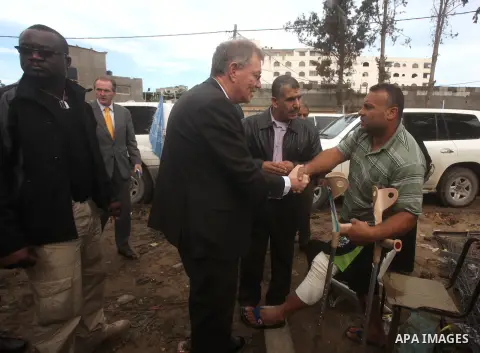 Robert H. Serry, the United Nations special coordinator for the Middle East Peace Process, talks with a wounded Palestinian man during his visit to Gaza Strip in Gaza City on Nov. 25, 2012. Photo by Ashraf Amra