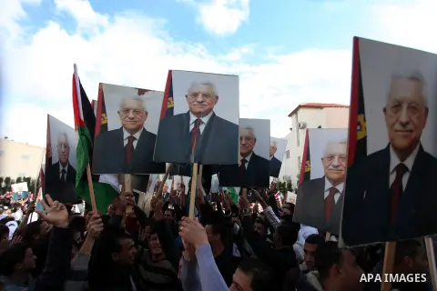 Palestinians hold posters of Palestinian President Mahmoud Abbas during a rally supporting the Palestinian UN bid for observer state status, in the West Bank city of Ramallah, Sunday, Nov. 25, 2012. The Palestinians will...