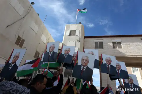 Palestinians hold posters of Palestinian President Mahmoud Abbas during a rally supporting the Palestinian UN bid for observer state status, in the West Bank city of Ramallah, Sunday, Nov. 25, 2012. The Palestinians will...