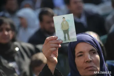 Palestinian women hold a poster of Palestinian prisoners during a protest calling for the release them from Israeli jails and in support of prisoners on hunger strike in front of Red Cross, in Gaza city on 26 November 20...
