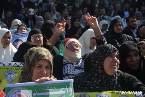 Palestinian women hold a poster of Palestinian prisoners during a protest calling for the release them from Israeli jails and in support of prisoners on hunger strike in front of Red Cross, in Gaza city on 26 November 20...