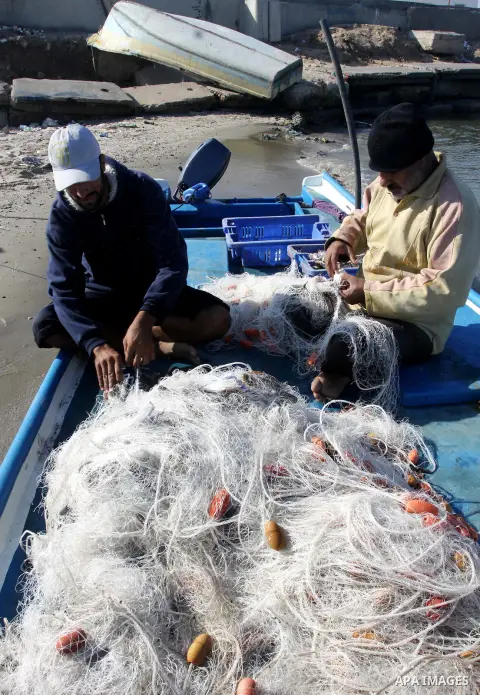 Palestinian fishermen prepare their boats in the port of Gaza on the Mediterranean coast, on Nov. 26, 2012, as a fragile truce between Israel and militant groups in Gaza enters its third day. Israel slammed Palestinian p...