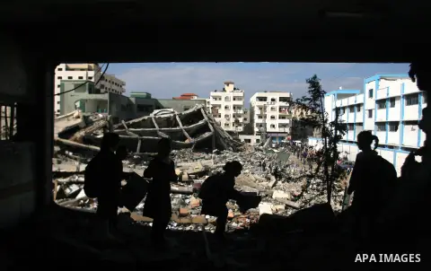 Palestinian school girls walk in a destroyed classroom on November 26, 2012 in Rafah southern Gaza strip. The school was damaged some days ago, before a truce between Hamas and Israel ended eight days of cross border att...