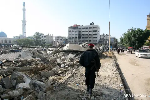 A Palestinian policeman walks next to the rubble of a destroyed school on November 26, 2012 in Rafah southern Gaza strip. The school was damaged some days ago, before a truce between Hamas and Israel ended eight days of...