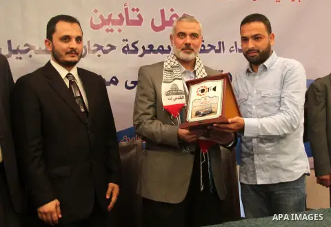 Palestinian Prime Minister in Gaza strip Ismail Haniyeh honors Ashraf Amra, in Gaza city on November 26, 2012. Amra works in APAimages photo agency, he was wounded after an Israeli air strike targeted a media bulding in...