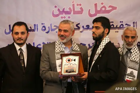Palestinian Prime Minister in Gaza strip Ismail Haniyeh honors a wounded journalist during a ceremony in Gaza city on November 26, 2012. Israeli aircraft killed 3 and wounded more than 17 journalists in the Israeli milit...