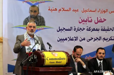 Palestinian Prime Minister in Gaza strip Ismail Haniyeh speaks during a ceremony to honor the wounded journalists in Gaza city on November 26, 2012. Israeli aircraft killed 3 and wounded more than 17 journalists in the I...