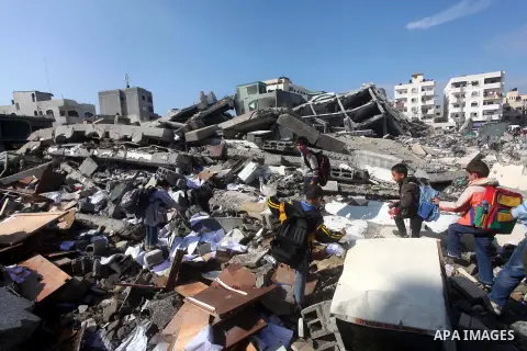 Palestinian school boys walk in the rubble left after days of Israeli air strikes destroyed the Hamas Interior Ministry in Gaza City. n November 26, 2012. The school was damaged some days ago, before a truce between Hama...