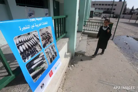 A Palestinian schoolgirl walks at a damaged school after days of Israeli air strikes destroyed the Hamas Interior Ministry in Gaza City. n November 26, 2012. The school was damaged some days ago, before a truce between H...