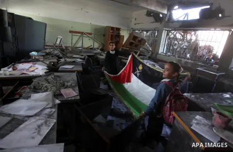 Palestinian school girls inspect the damage in a classroom in a destroyed school after days of Israeli air strikes destroyed the Hamas Interior Ministry in Gaza City. n November 26, 2012. The school was damaged some days...