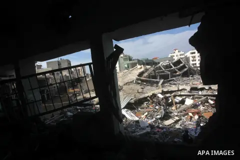 Palestinian school boys walk in the rubble left after days of Israeli air strikes destroyed the Hamas Interior Ministry in Gaza City. n November 26, 2012. The school was damaged some days ago, before a truce between Hama...