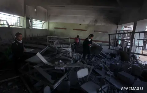 Palestinian school girls inspect the damage in a classroom in a destroyed school after days of Israeli air strikes destroyed the Hamas Interior Ministry in Gaza City. n November 26, 2012. The school was damaged some days...