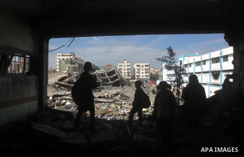 Palestinian school boys walk in the rubble left after days of Israeli air strikes destroyed the Hamas Interior Ministry in Gaza City. n November 26, 2012. The school was damaged some days ago, before a truce between Hama...