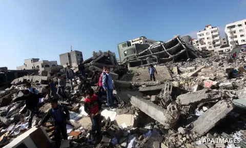 Palestinian school boys walk in the rubble left after days of Israeli air strikes destroyed the Hamas Interior Ministry in Gaza City. n November 26, 2012. The school was damaged some days ago, before a truce between Hama...