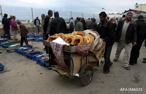 Palestinian men sell fish at a market in Gaza City November 27, 2012. Israel eased restrictions on Gaza fishermen on Saturday, further implementing truce brokered by Egypt after a week of fierce fighting, Palestinian off...