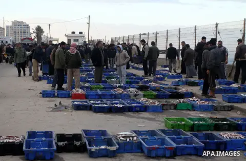 Palestinian men sell fish at a market in Gaza City November 27, 2012. Israel eased restrictions on Gaza fishermen on Saturday, further implementing truce brokered by Egypt after a week of fierce fighting, Palestinian off...