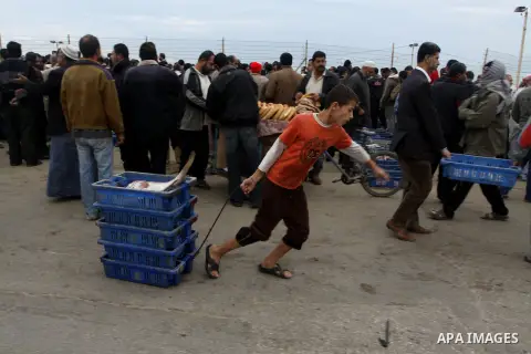 Palestinian men sell fish at a market in Gaza City November 27, 2012. Israel eased restrictions on Gaza fishermen on Saturday, further implementing truce brokered by Egypt after a week of fierce fighting, Palestinian off...